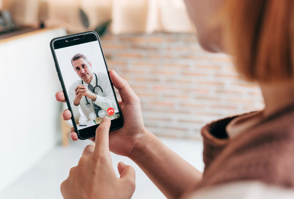 Person speaking with doctor through video on smartphone