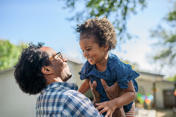 Happy man holding happy child