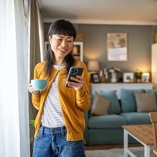 woman reviewing her health insurance benefits on her mobile phone