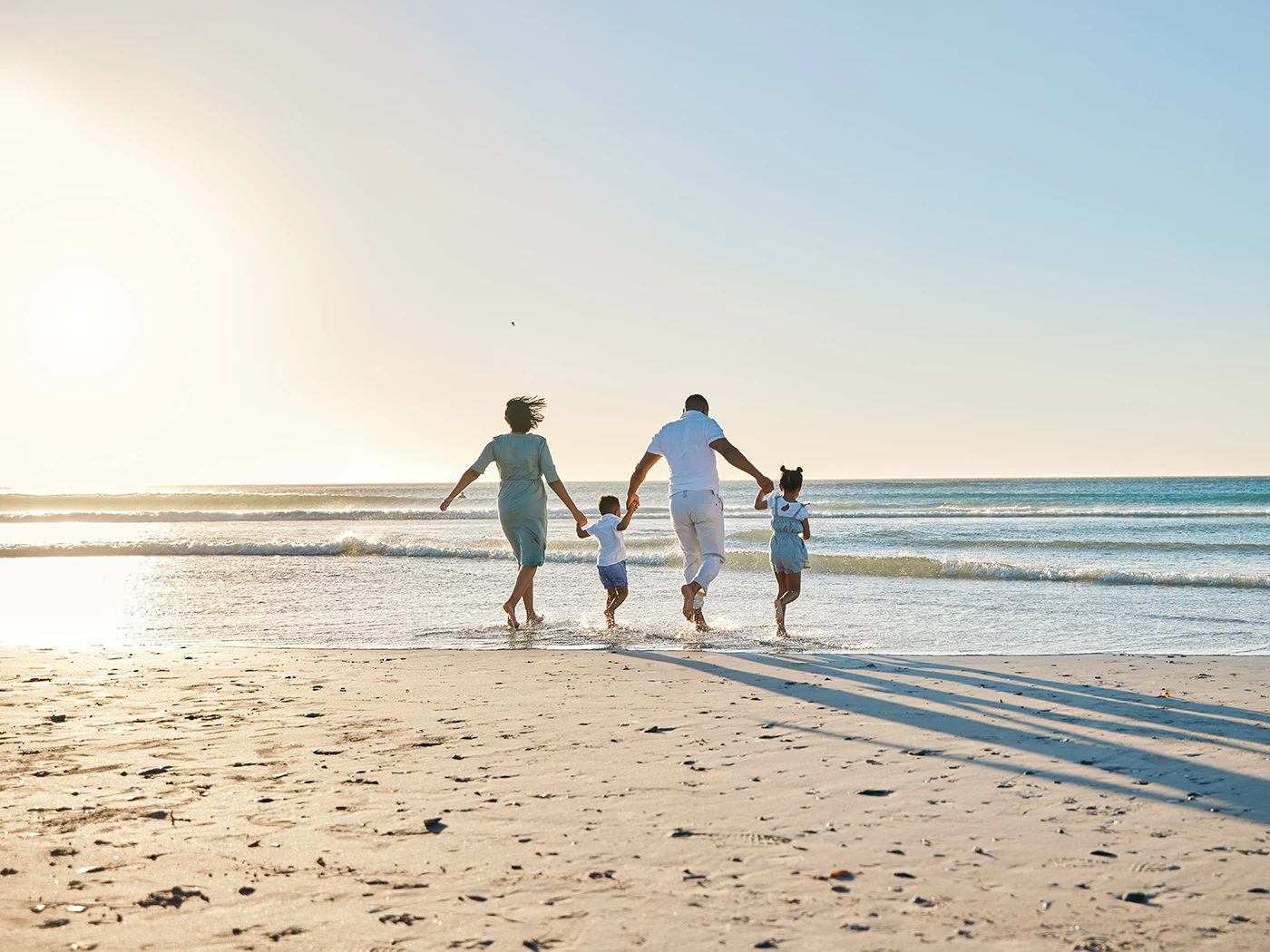 A happy family walking towards the sea