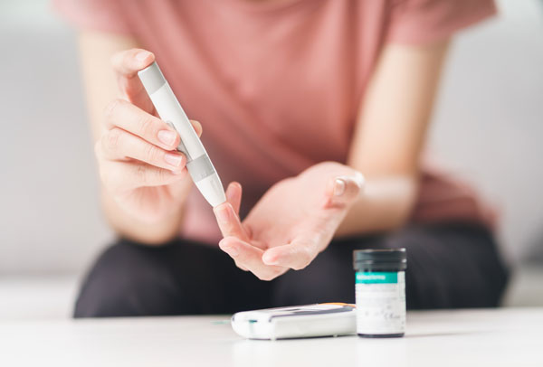 Person taking a blood sugar test