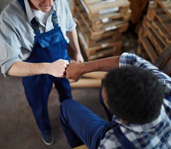 Two men fist bumping