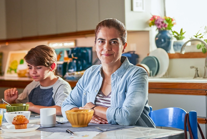 woman sitting in kitchen with her son