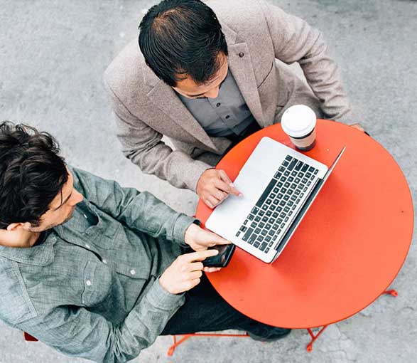 Two men on laptop