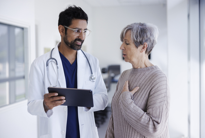 Doctor and patient in conversation, looking at digital tablet