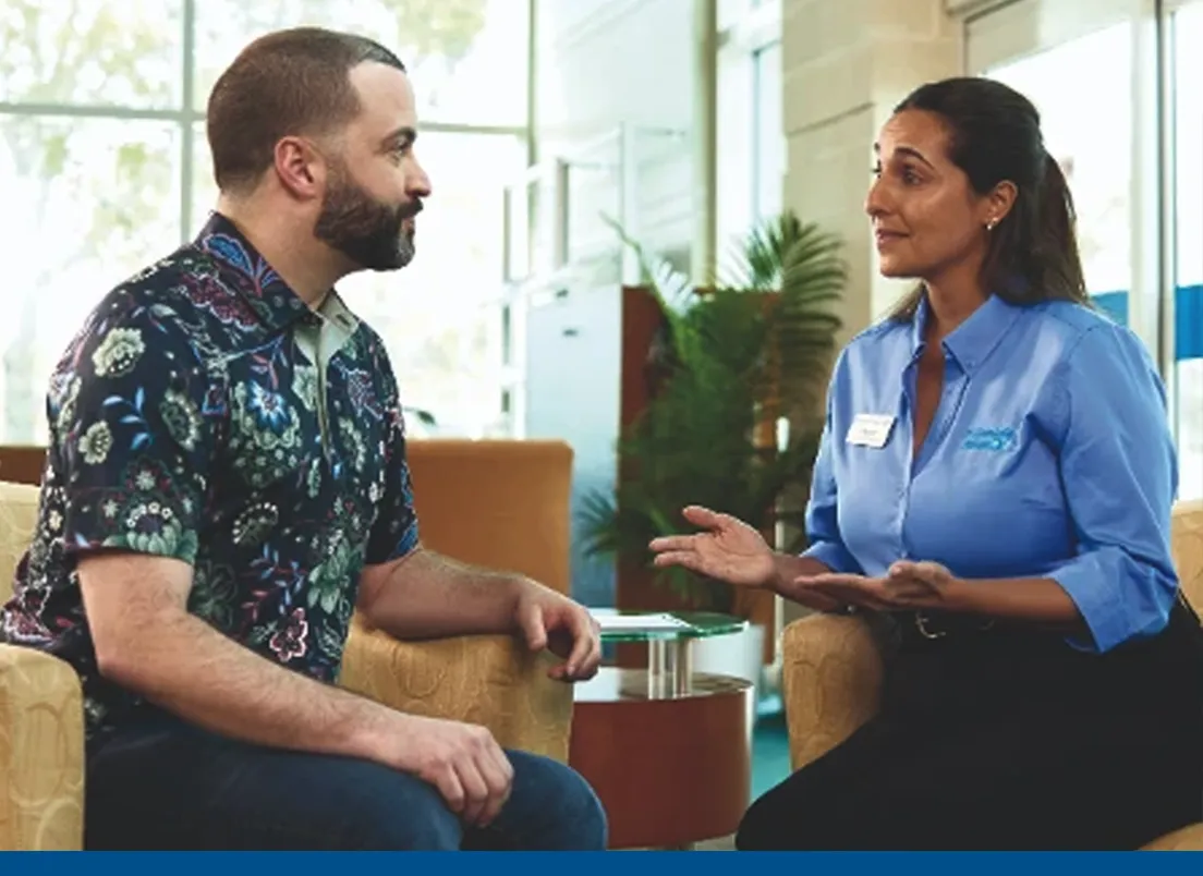 man talking with a Florida Blue agent at a Florida Blue Center