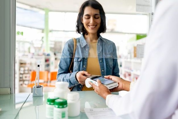 woman purchasing prescription medications with discount card