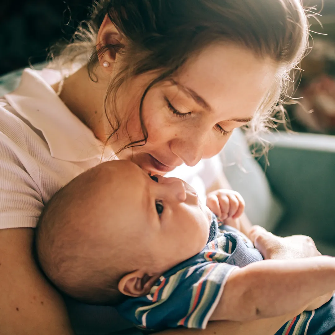 young woman holding her baby