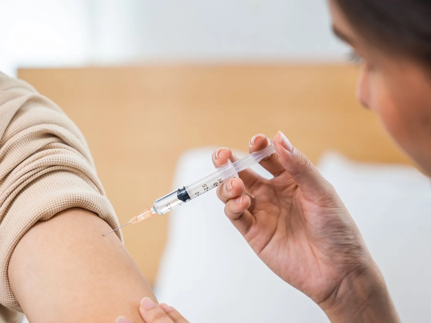 Someone gets a vaccine at the doctor’s office