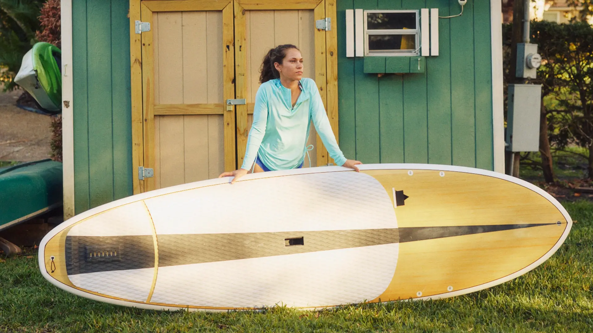 woman standing in the sun with her paddleboard