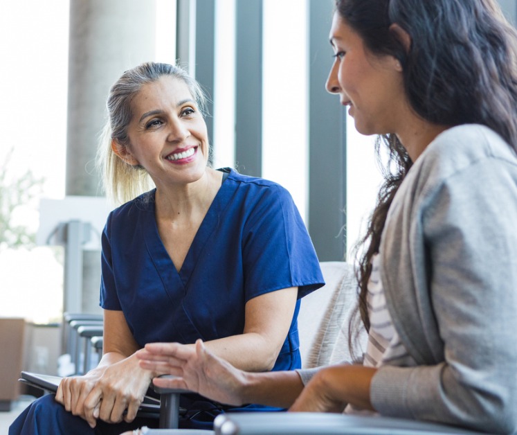 doctor smiling while talking to a patient