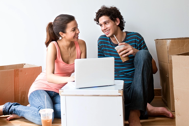 new florida residents unpacking boxes and drinking coffee