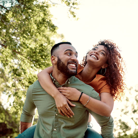 Man carrying partner on back