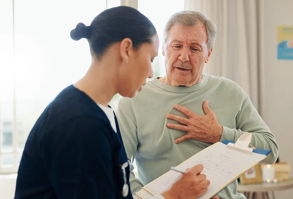 Older man talking to nurse about his heart palpitations