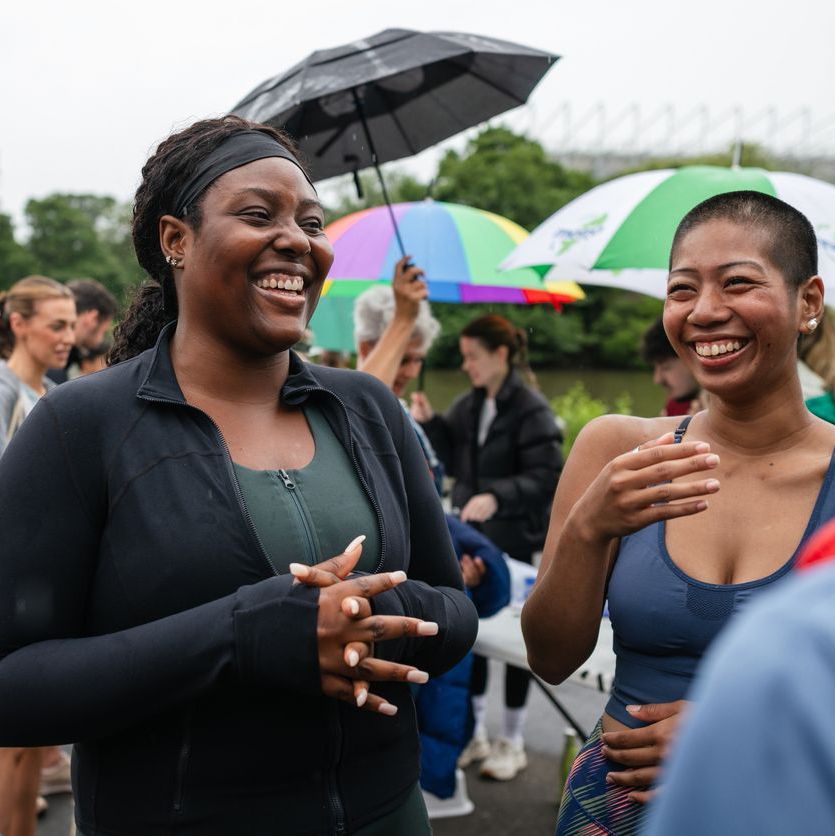 women in running gear laughing together outside