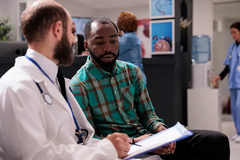 employee talking with doctor about health care costs