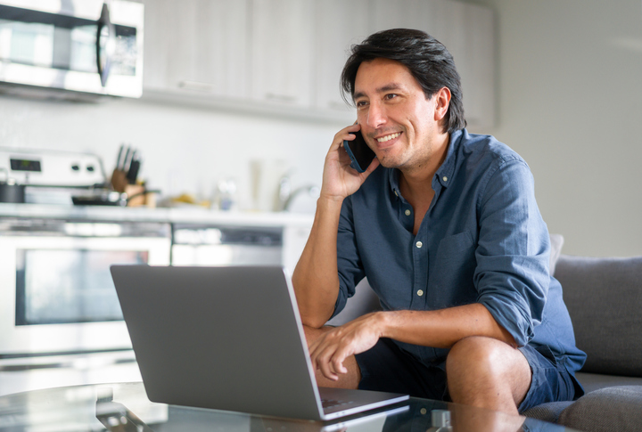 man smiling at computer