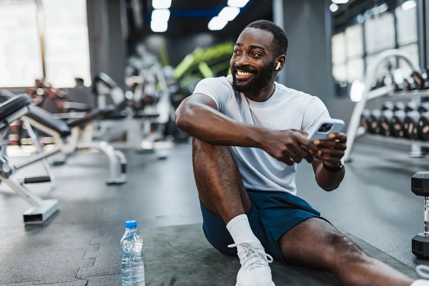 man on gym floor after completing a workout to improve heart health