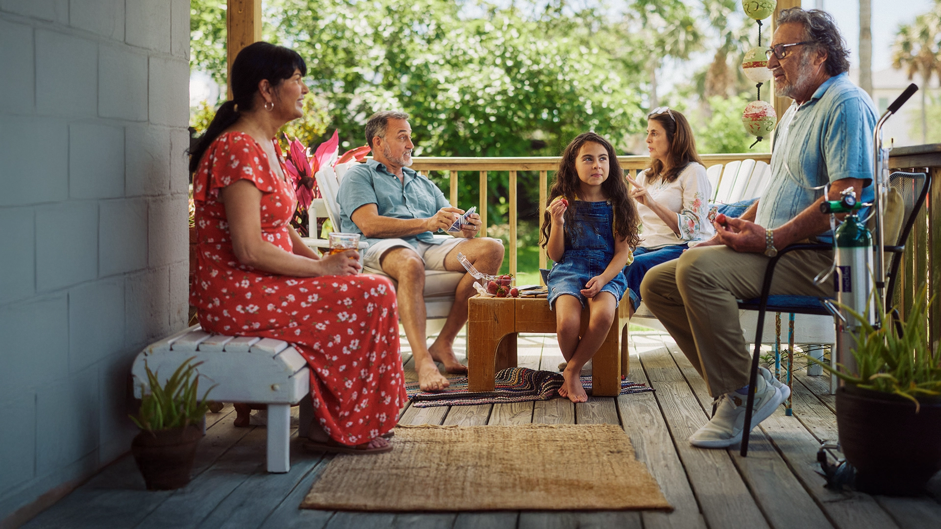 family sitting on porch chatting