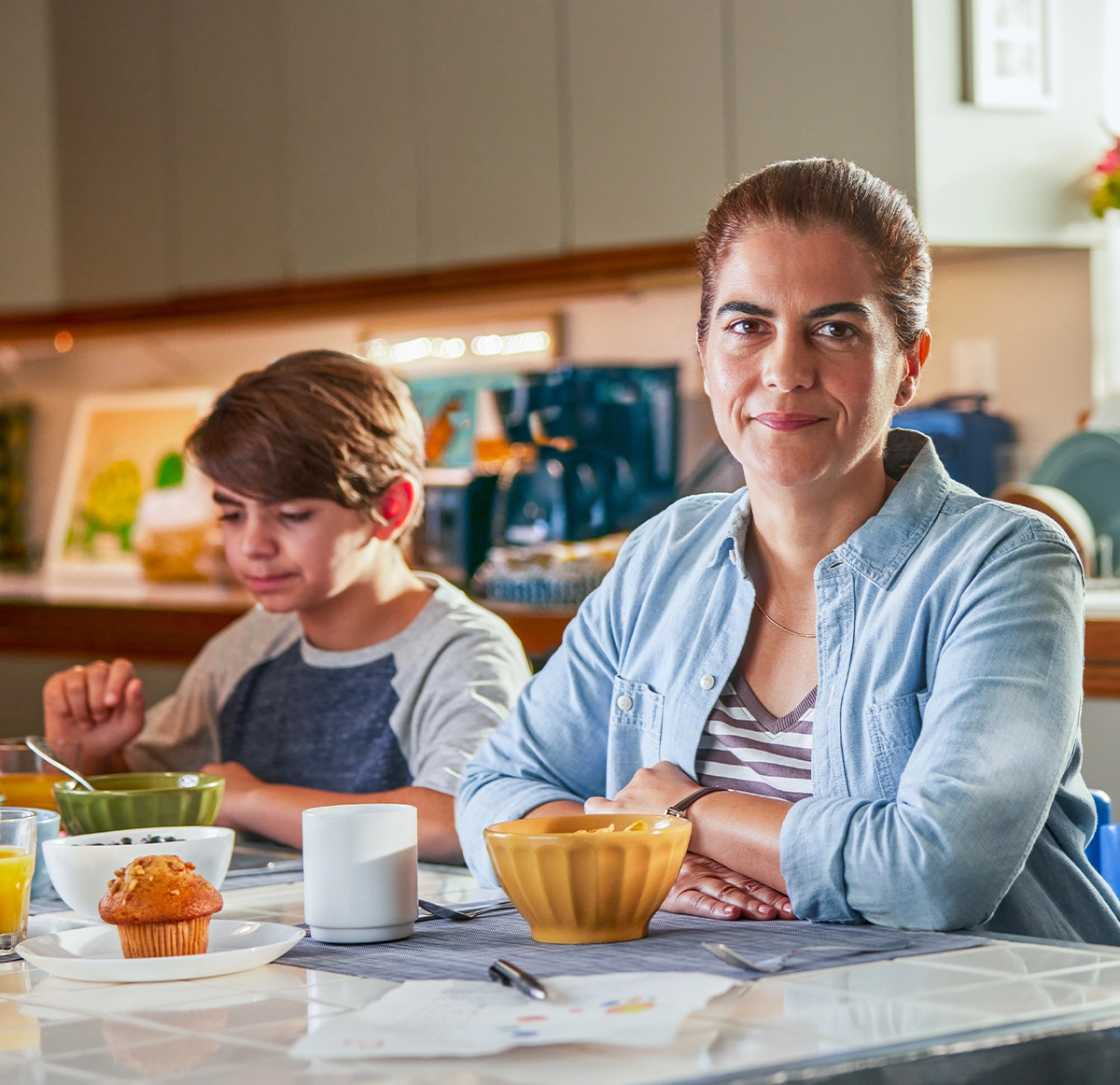 woman sitting at the dining table with her son