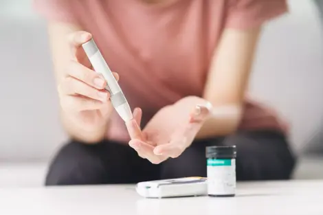 Person taking a blood sugar test